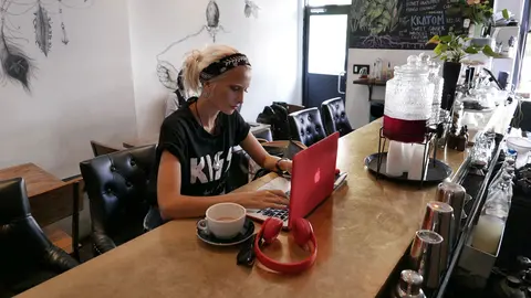 Woman-entrepreneur-work-laptop-headphone-business-kiss-t-shirt