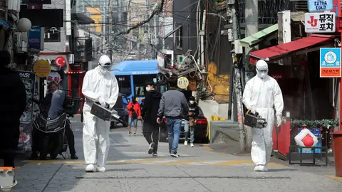 Quarantine workers spray disinfectants at night spots of Itaewon neighborhood, following the coronavirus disease (COVID-19) outbreak, in Seoul, South Korea, May 11, 2020. Yonhap/via REUTERS