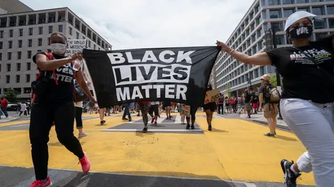 Demonstrators carry a Black Lives Matter flag during a march against police brutality near the White House on Saturday. National Guard troops will start withdrawing from Washington, US President Donald Trump said Sunday, nearly a week after he deployed federal forces to the capital city. Photo: Sait Serkan Gurbuz/ZUMA Wire/dpa