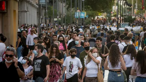 20 June 2020, Spain, Barcelona: People wearing face masks walk along the shopping street Portal del Angel after they were allowed to move freely again as Spain is no longer in a coronavirus emergency. Photo: Jordi Boixareu/ZUMA Wire/dpa