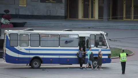 Ukraine, Lutsk: An elderly woman, a teenager and a pregnant woman leave the bus where a heavily armed man holds more than ten people hostage on a bus. All hostages aboard a bus were freed as authorities stormed the vehicle and captured the armed attacker. Photo: -/Ukrinform/dpa