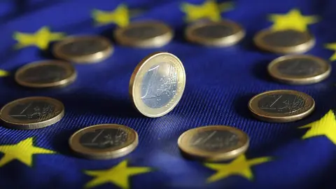 FILED - 04 July 2011, Baden-Wuerttemberg, Karlsruhe: Euro coins lie on a Euro flag. The rate of inflation in the 19 countries of the eurozone recuperated slightly to 0.4 per cent in July, according to a first estimate from EU statistical office Eurostat. Photo:Uli Deck/dpa.