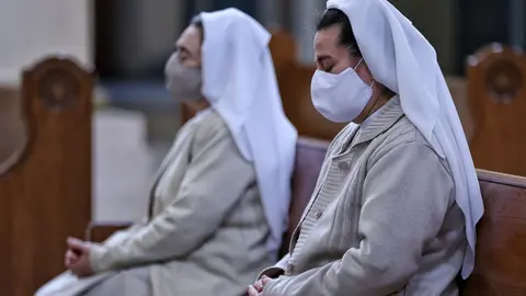 09 August 2020, Colombia, Bogota: Two nuns with face masks pray during a mass in the Cathedral of the Immaculate Conception. Photo: Álvaro Tavera/dpa.