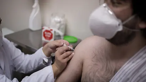 30 July 2020, Brazil, Sao Paulo: A volunteer at the Emilio Ribas Institute for Infectiology receives a newly developed coronavirus vaccine as part of its third testing phase by Chinese pharmaceutical company Sinovac. Photo: Andre Lucas/dpa.