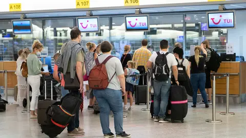 15 August 2020, Lower Saxony, Hanover: Passengers queue up at the Tui check-in counters at Hannover Airport. Germany has declared nearly all of Spain, including the island of Mallorca, as risky areas following a spike of coronavirus cases. Photo: Peter Steffen/dpa.