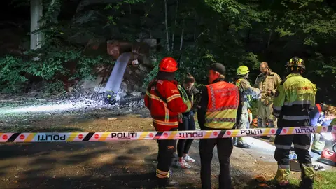 30 August 2020, Norway, Oslo: Rescue workers stand at the scene, where at least 24 people, mainly young people, were taken to hospital with suspected carbon monoxide poisoning after attending a party in an underground bunker. Photo: Geir Olsen/dpa.
