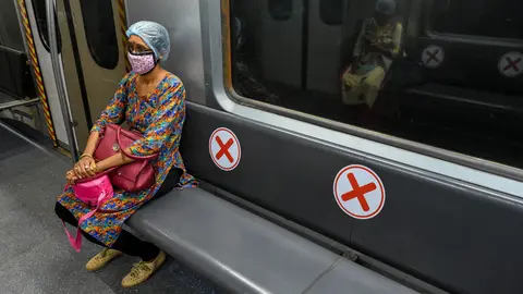 09 September 2020, India, Kolkata: A woman wearing a face mask sits inside a metro car of the Kolkata metro, which prepares to resume full service during the fourth stage easing the coronavirus lockdown. Photo: Debarchan Chatterjee/dpa.