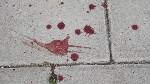 13 September 2020, North Rhine-Westphalia, Stolberg: Bloodstains seen on a sidewalk after a possibly Islamist-motivated stabbing attack against a car driver in Stolberg. German police on Sunday detained a man suspected of stabbing the driver of a car in Stolberg, near the western city of Aachen, in what is being treated as a possible Islamist attack. Photo: David Young/dpa.