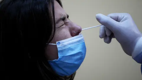 21 September 2020, Greece, Athens: A medic takes a swab sample from a teacher during a coronavirus testing campaign. Photo: Aristidis Vafeiadakis/dpa.