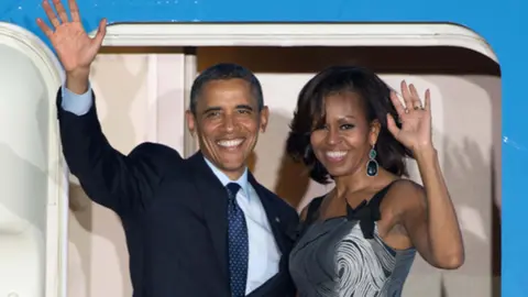 Barack Obama and his wife Michelle wave goodbye as they leave from Berlin, in 2013. Photo: Maurizio Gambarini/dpa/File Photo.