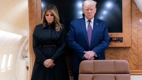 HANDOUT - 11 September 2020, US, Pennsylvania: US President Donald Trump (R) and First Lady Melania Trump bow their heads during a moment of silence aboard Air Force One to mark the 19th anniversary of the 9/11 terrorist attacks on the World Trade Center. Photo: Shealah Craighead/White House.