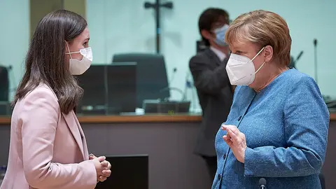 HANDOUT - 01 October 2020, Belgium, Brussels: German Chancellor Angela Merkel (R)  speaks with Finnish Prime Minister Sanna Marin during the EU summit. Photo: Mario Salerno/European Council.