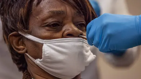 14 November 2020, US, Toledo: A medical worker in protective clothing takes a nasal swab from a patient for a Coronavirus test. Photo: Stephen Zenner/SOPA Images via ZUMA Wire/dpa