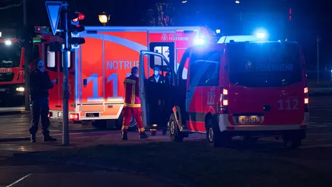 26 December 2020, Berlin: Emergency vehicles of the fire department are parked in Stresemann street after a shooting in the early morning. According to initial information, four people were injured, some of them seriously. Photo: Paul Zinken/dpa
