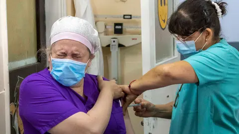 29 December 2020, Argentina, Firmat: A health care worker of the San Martin Hospital receieves her dose of the Russian Sputnik V vaccine amid a nationwide vaccination campaign. Photo: Patricio Murphy/ZUMA Wire/dpa