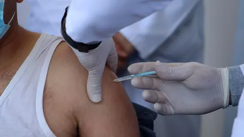 02 February 2021, Palestinian Territories, Bethlehem: A Palestinian health worker receives a Moderna Coronavirus (Covid-19) vaccine. Palestinian Authority began vaccinating health workers after a global pressure campaign on Israel to provide the vaccines. Photo: Mosab Shawer/APA Images via ZUMA Wire/dpa