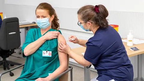A healthcare worker gets vaccinated in Helsinki. Photo: @HUS/file photo.