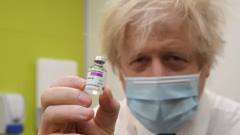 15 February 2021, United Kingdom, Orpington: UK Prime Minister Boris Johnson holds a vial of AstraZeneca coronavirus vaccine during his visit to a vaccination centre at the Health and Well-being Centre in Orpington, south-east London. Photo: Jeremy Selwyn/Evening Standard via PA Wire/dpa