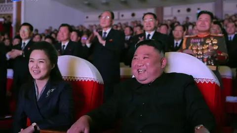 16 February 2021, North Korea, Pyongyang: A photo released by the Korean Central News Agency shows North Korean Leader Kim Jong-un (R) and his wife Ri Sol Ju watching a performance at the Mansudae Art Theater to mark the birthday of Kim's father, Kim Jong Il, who died in 2011, state media reported Wednesday. Kim's wife, Ri Sol Ju, has appeared in public for the first time in more than a year. Photo: -/YNA/dpa