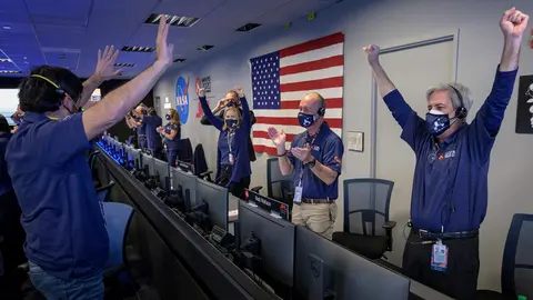 18 February 2021, US, Pasadena: Members of the NASA Perseverance Mars rover mission team cheer as the spacecraft successfully land on Mars, at the NASA Jet Propulsion Laboratory in Pasadena. NASA's Mars rover Perseverance landed on the Red Planet on Thursday after a roughly 480-million-kilometre journey through space, the first probe from Earth to reach Mars since 2018. Photo: Bill Ingalls/Nasa/Planet Pix via ZUMA Wire/dpa