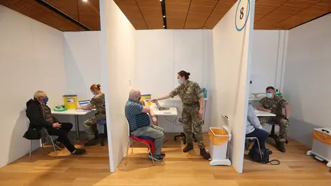 Michael Maddocks (left) and James Logan (right) receive their coronavirus vaccine in Edinburgh. More than 20 million people in Britain have received their first coronavirus vaccine dose, Health Secretary Matt Hancock said on Sunday, a figure that corresponds to about 30 per cent of the population. Photo: Andrew Milligan/PA Wire/dpa