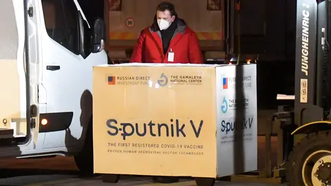 01 March 2021, Slovakia, Kosice: A worker unloads boxes of Sputnik V's Coronavirus vaccine doses from an aircraft upon its arrival from Moscow at Kosice International Airport. Photo: Frantiek Iván/TASR/dpa