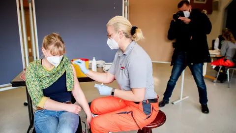 10 March 2021, Lower Saxony, Hanover: A woman receives her dose of the AstraZeneca COVID-19 vaccine at a vaccination centre. Photo: Hauke-Christian Dittrich/dpa