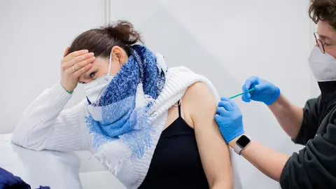 08 March 2021, North Rhine-Westphalia, Cologne: Bianca Ahlemeier, a childminder in home daycare, reacts as she receive her AstraZeneca's COVID-19 vaccine dose at a vaccination centre. Photo: Rolf Vennenbernd/dpa