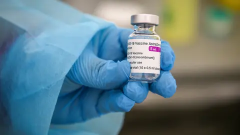 06 March 2021, France, Marseille: A health worker holds a vial of the AstraZeneca COVID-19 vaccine during a mass vaccination. Photo: Denis Thaust/SOPA Images via ZUMA Wire/dpa