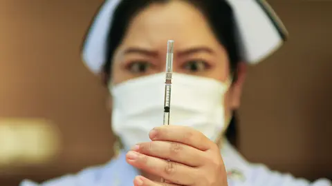 12 March 2021, Thailand, Bangkok: A health worker prepares a dose of AstraZeneca's COVID-19 vaccine at the Bamrasnaradura Infectious Diseases Institute in Nonthaburi province on the outskirts of Bangkok. Photo: Chaiwat Subprasom/SOPA Images via ZUMA Wire/dpa