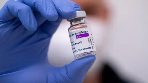 FILED - 02 March 2021, Bavaria, Munich: An employee holds a vial of AstraZeneca's Corona vaccine at the police vaccination center in Munich. Germany, France and Italy on Monday became the latest countries to temporarily suspend use of the Covid-19 vaccine developed by AstraZeneca over blood clot concerns, joining others in Europe including Ireland, Denmark, Norway and the Netherlands. Photo: Sven Hoppe/dpa