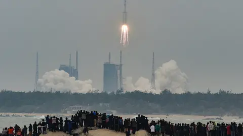 FILED - People watch China's new medium-size rocket, Long March 8, lifting from Wenchang Space Launch Center. Debris from a Chinese rocket threatens to fall to Earth in the next few days after it was used to launch the core module of China's new space station. Photo: Lu Qijian/SIPA Asia via ZUMA Wire/dpa
