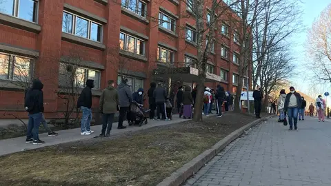 People queuing on Friday morning outside Migri's office in Helsinki. Photo: Bambi Dang.