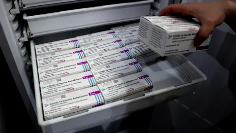 11 May 2021, Saxony-Anhalt, Irxleben: A pharmacist removes boxes of Coronavirus vaccine doses from the manufacturer Astrazeneca from a freezer in the central vaccine warehouse of the state of Saxony-Anhalt. Photo: Ronny Hartmann/dpa