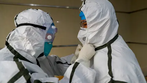 FILED - Medical staff put on their protective suits at a hospital in Wuhan, ground zero for the coronavirus outbreak. China rejected US President Joe Biden's order for a new investigation by US intelligence agencies into the origins of the coronavirus, accusing the US of trying to politicize the search. Photo: -/TPG via ZUMA Press/dpa