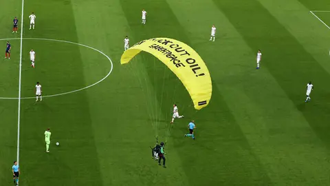 15 June 2021, Bavaria, Munich: A Greenpeace activist lands on the pitch before the start of the UEFA EURO 2020 Group F soccer match between France and Germany at the Allianz Arena. Photo: Christian Charisius/dpa