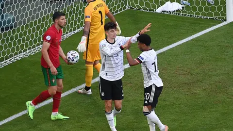 19 June 2021, Bavaria, Munich: Germany's Kai Havertz celebrates scoring his side's third goal with team mate Serge Gnabry during the UEFA EURO 2020 Group F soccer match between Portugal and Germany at the Allianz Arena. Photo: Federico Gambarini/dpa