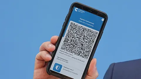 10 June 2021, England, Berlin: German Minister of Health Jens Spahn shows the app for the digital vaccination certificate during a press conference on the coronavirus situation. Photo: Michael Kappeler/dpa