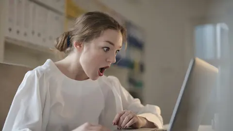 Woman surprise shock laptop computer. Photo by Andrea Piacquadio from Pexels.