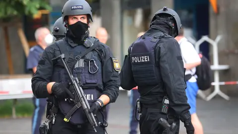 25 June 2021, Bavaria, Wuerzburg: Police officers stand in the city center near to the scene, where three people have been killed and five injured in a knife attack in downtown Wuerzburg on Friday. The alleged attacker was caught and detained, police said. Photo: Karl-Josef Hildenbrand/dpa.