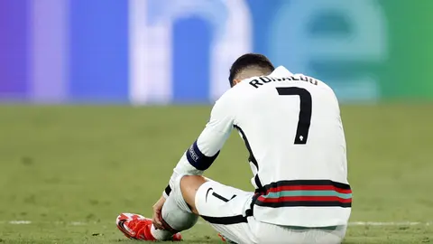 27 June 2021, Spain, Seville: Portugal's Cristiano Ronaldo lies on the turf after a collision during the UEFA EURO 2020 round of 16 soccer match between Belgium and Portugal at La Cartuja Stadium. Photo: Bruno Fahy/BELGA/dpa