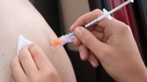 02 July 2021, Canada, Kingston: A person receives their COVID-19 vaccine during a drive-thru clinic at Richardson stadium. Photo: Lars Hagberg/The Canadian Press via ZUMA/dpa