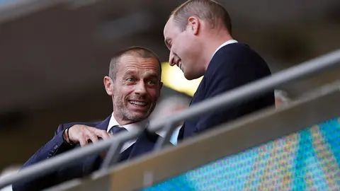 07 July 2021, United Kingdom, London: Prince William, Duke of Cambridge, talks with UEFA president Aleksander Ceferin (L) in the stands prior to the start of the UEFA Euro 2020 semi-final soccer match between England and Denmark at Wembley Stadium. Photo: Mike Egerton/PA Wire/dpa