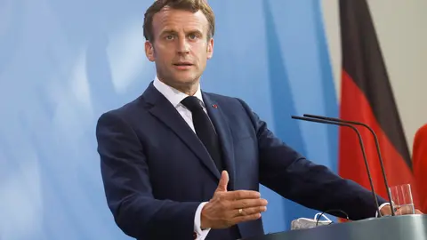 FILED - 18 June 2021, Berlin: French President Emmanuel Macron makes a statement to journalists together with German Chancellor Angela Merkel (not pictured). Macron will hold an extraordinary meeting of the Defense Council on the “Pegasus” hacking of his phone. Photo: Axel Schmidt/Reuters-Pool/dpa
