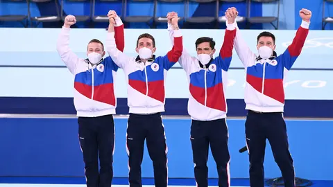 26 July 2021, Japan, Tokyo: Russian Olympic Committee's (ROC) gold medallists, Denis Abliasin, David Belyavsky, Artur Dalaloyan and Nikita Nagorny celebrates on the podium during the medal ceremony of the artistic gymnastic men's team final at the Ariake Gymnastics Centre, part of the Tokyo 2020 Olympic Games. Photo: Marijan Murat/dpa