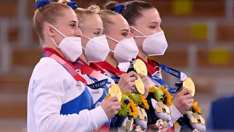 27 July 2021, Japan, Tokyo: (L-R) Gold medallist members of the Russian Olympic Committee team (ROC), Lilia Akhaimova, Viktoria Listunova, Angelina Melnikova and Vladislava Urazova celebrate on the podium during the medal ceremony of the Women's Team Artistic Gymnastics Final at the Ariake Gymnastics Centre, at the Tokyo 2020 Olympic Games. Photo: Marijan Murat/dpa