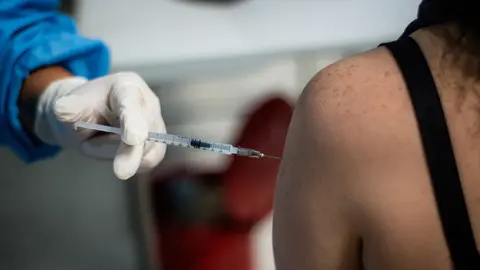 02 August 2021, Colombia, Bogota: A women gets a dose of the Moderna Coronavirus (Covid-19) vaccine vial as public transport drivers and people from ages 25 to 30 start their vaccination phase. Photo: Ximena Rubio/LongVisual via ZUMA Press Wire/dpa