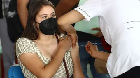 19 August 2021, Mexico, Mexico City: A girl receives her Coronavirus (Covid-19) vaccine at the vaccination center in the municipality of Xochimilco. Photo: -/El Universal via ZUMA Press Wire/dpa