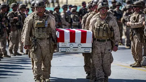 27 August 2021, Afghanistan, Kabul: A picture made available on 30 August 2021 shows US soldiers carry a coffin of one of the 11 Marines who were killed during operations at Hamid Karzai International Airport in Afghanistan before being airlifted home. US service members are assisting the Department of State with a Non-Combatant Evacuation Operation (NEO) in Afghanistan. Photo: -/U.S. Marines via ZUMA Press Wire Service/dpa