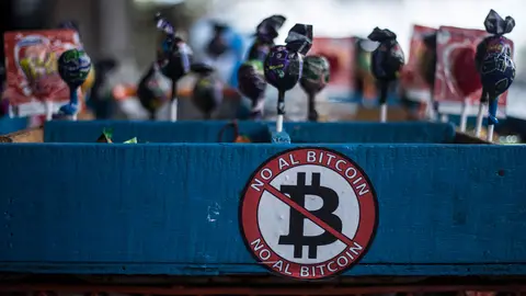 FILED - "No to Bitcoin," reads a sticker on a street stall selling lollipops and other sweets. Many street vendors have opposed the digital currency. The Central American state is nevertheless the first country in the world to take this step. A law to this effect had been passed three months ago and will now come into force on 07.09.2021. It stipulates that every merchant who is technically capable of accepting Bitcoin as a means of payment must do so. Photo: Víctor Peña/dpa